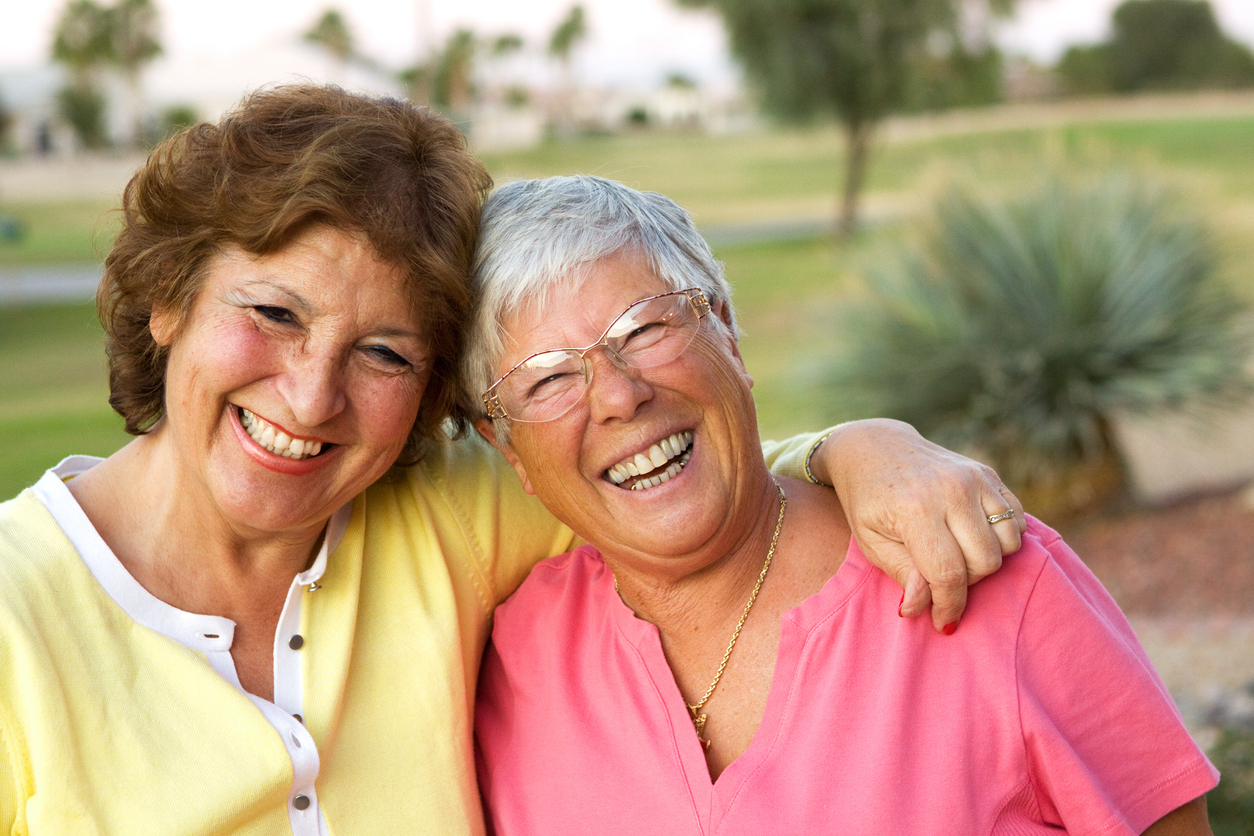 Two mature retired women enjoying a good laugh.