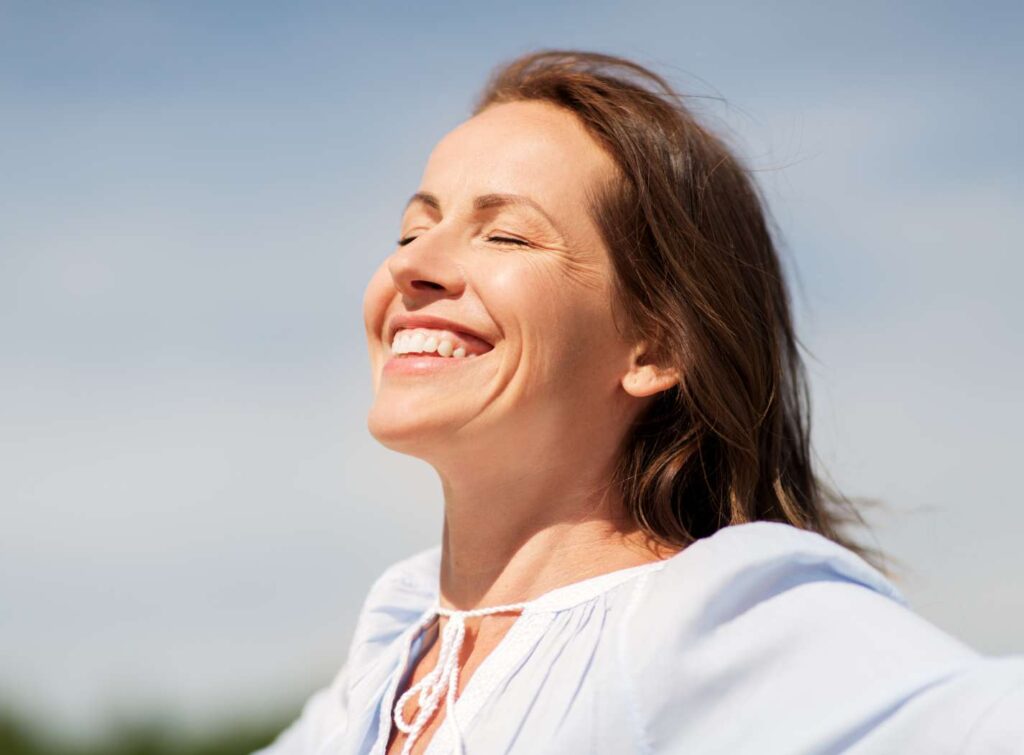 Happy woman smiling at the beach