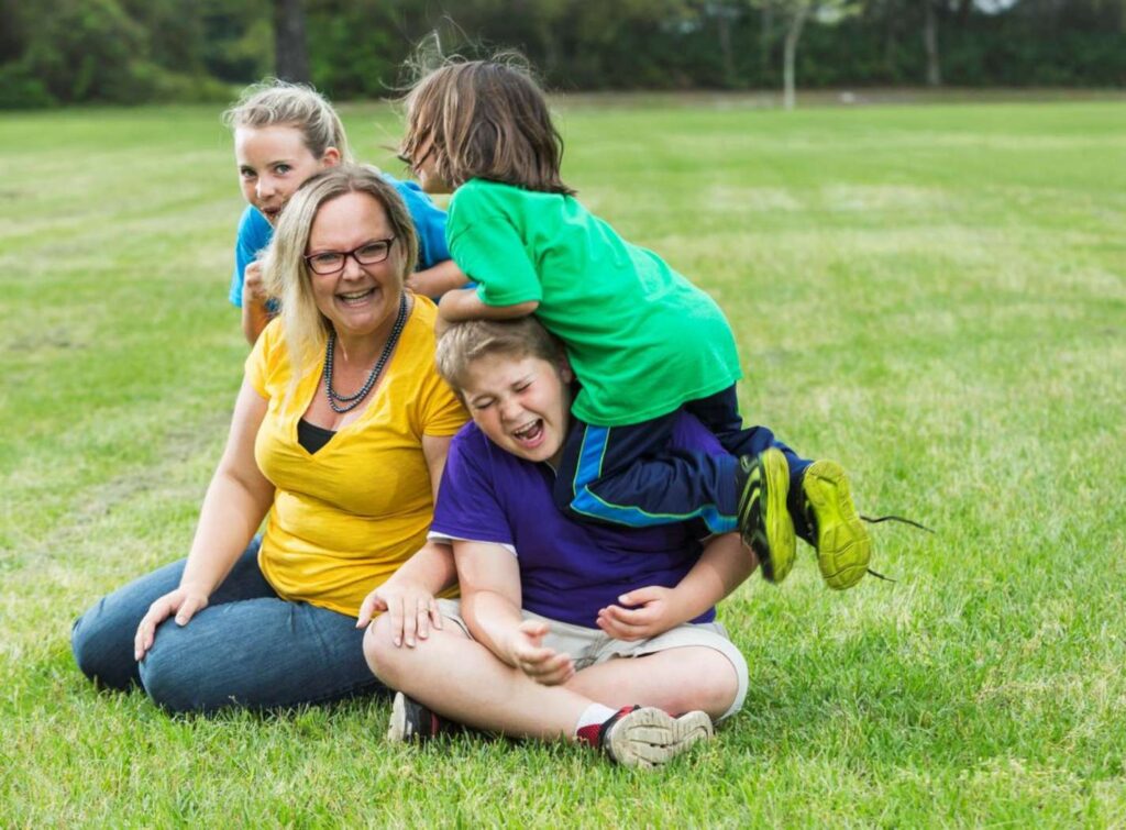 Children playing joyfully with adult.